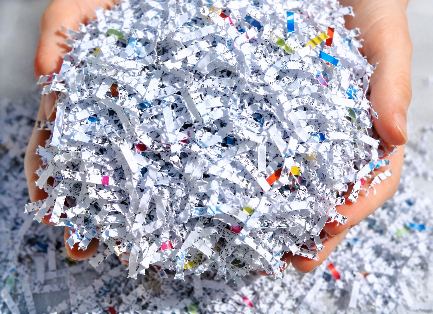 Cross-cut shredded paper held after secure document destruction